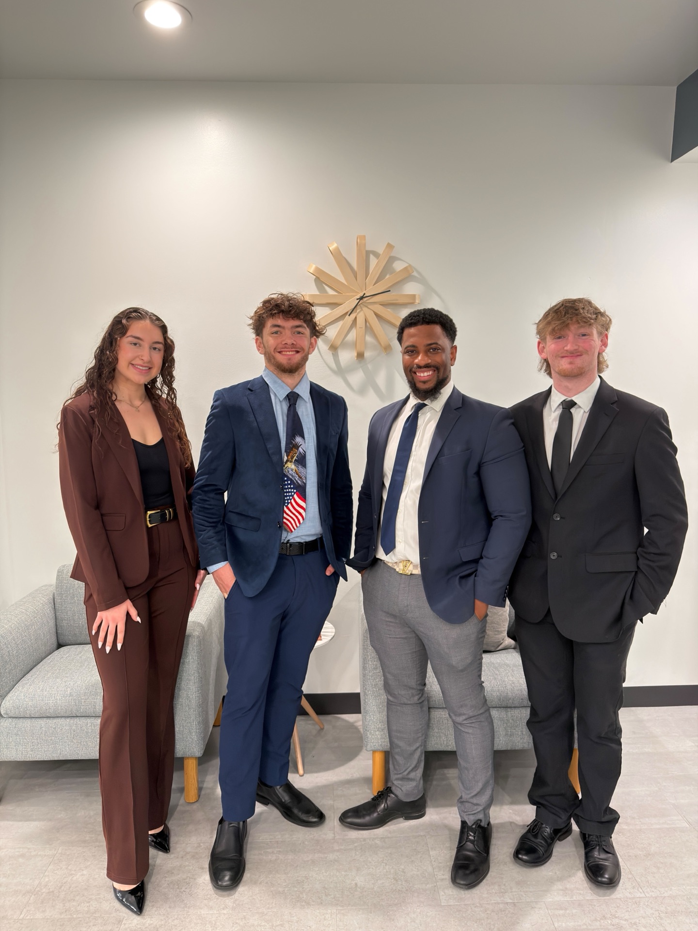 Essential Solutions Marketing team — four young professionals in business attire standing together in the Sacramento office